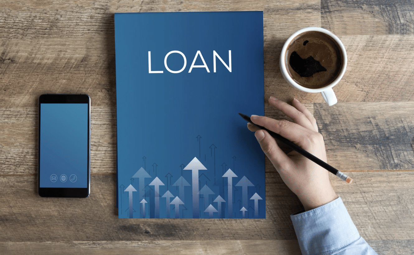 A loan document with. cup of coffee and a smartphone